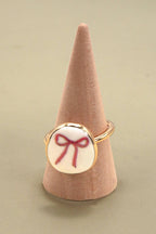 PORCELAIN GOLD EDGED BOW CHARM RING